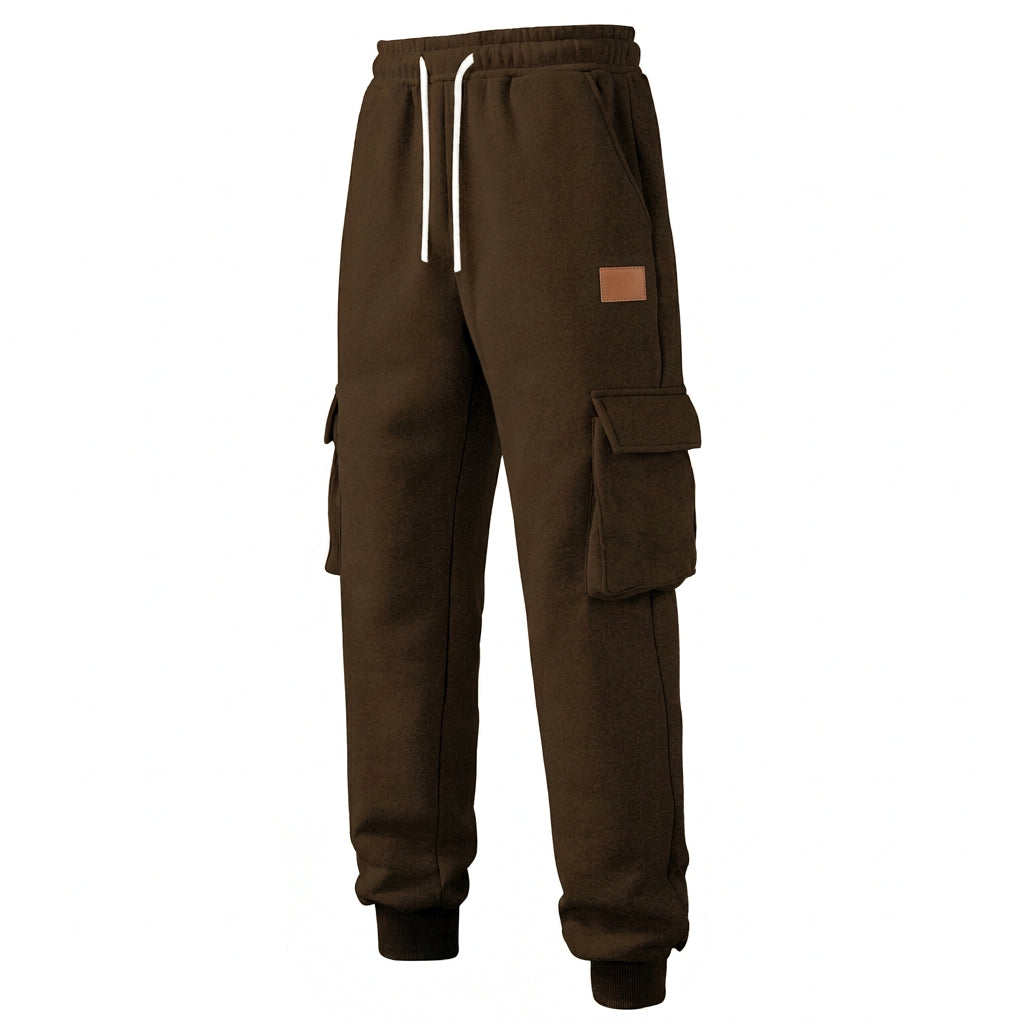 Brown cargo jogger sweatpants with a white drawstring, side cargo pockets, and ribbed ankle cuffs, shown against a plain white background