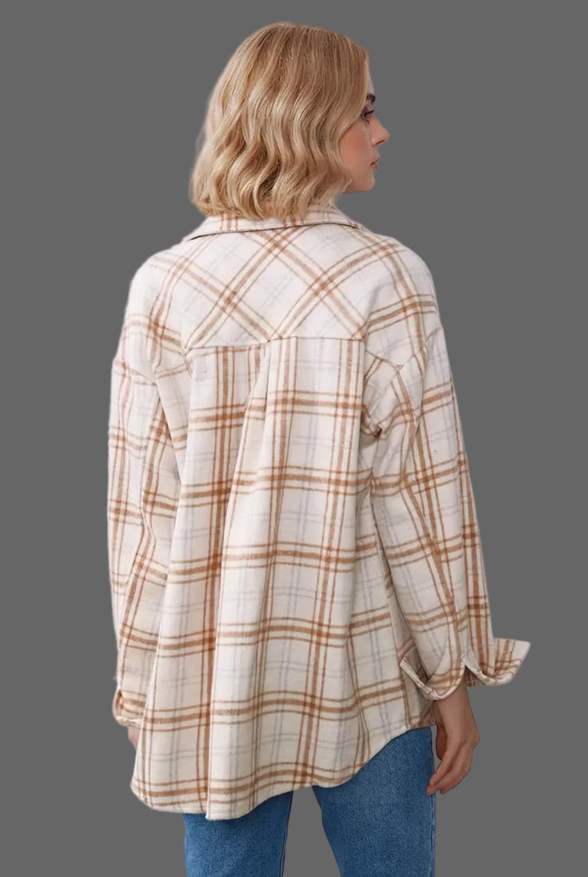 A woman shown from the back wearing an oversized cream-colored plaid button-up shirt with brown and tan lines, paired with blue jeans.