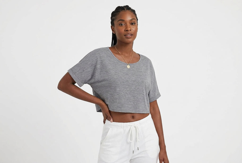 Gray off-shoulder top worn by a person on a white background