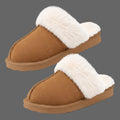A pair of slip-on mule slippers with a warm brown suede-like upper and thick white faux-fur trim