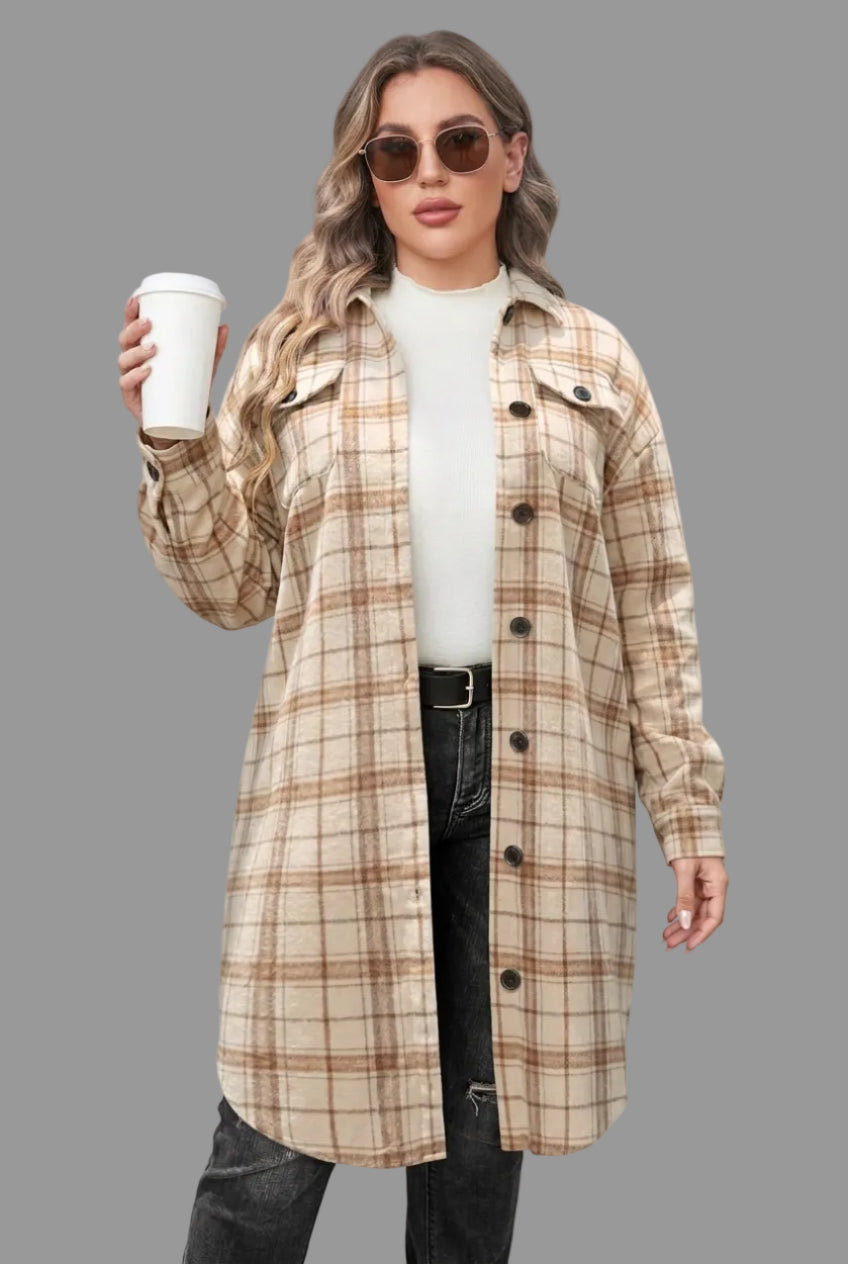 A woman models a beige and brown plaid button-up overshirt with a white shirt and pants while holding a coffee cup against a plain background.