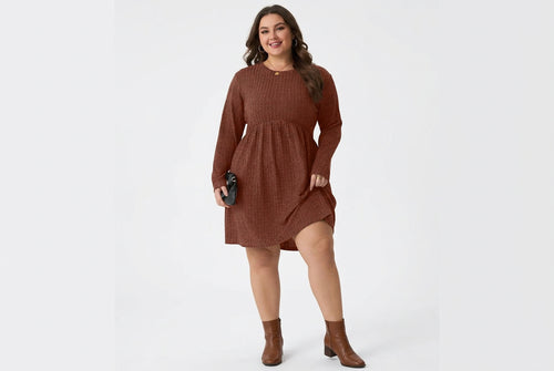 A woman wearing a rust-brown ribbed knit long-sleeve dress with a gathered waist and side pockets, holding a black clutch against a plain white background.