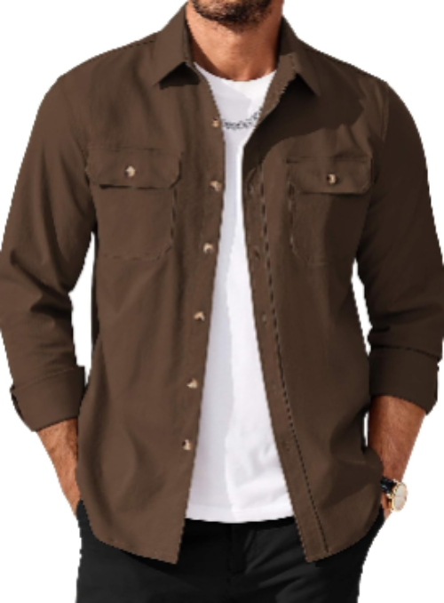 A man wearing a brown long-sleeve button-up shirt over a white t-shirt and black pants, shown from the chest down against a plain white background.