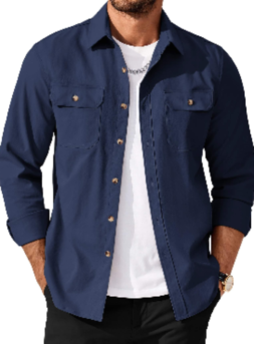 A man wearing a denim blue long-sleeve button-up shirt with two chest pockets, layered over a white t-shirt and black pants, shown against a plain white background.